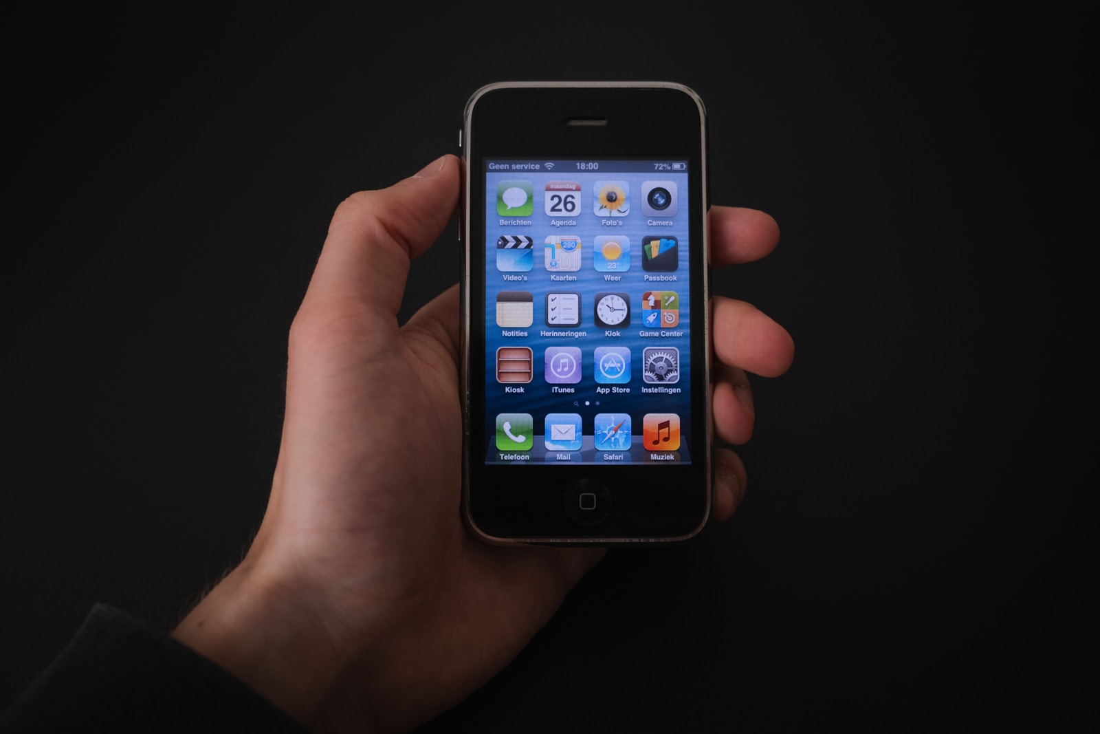person holding black iphone 4