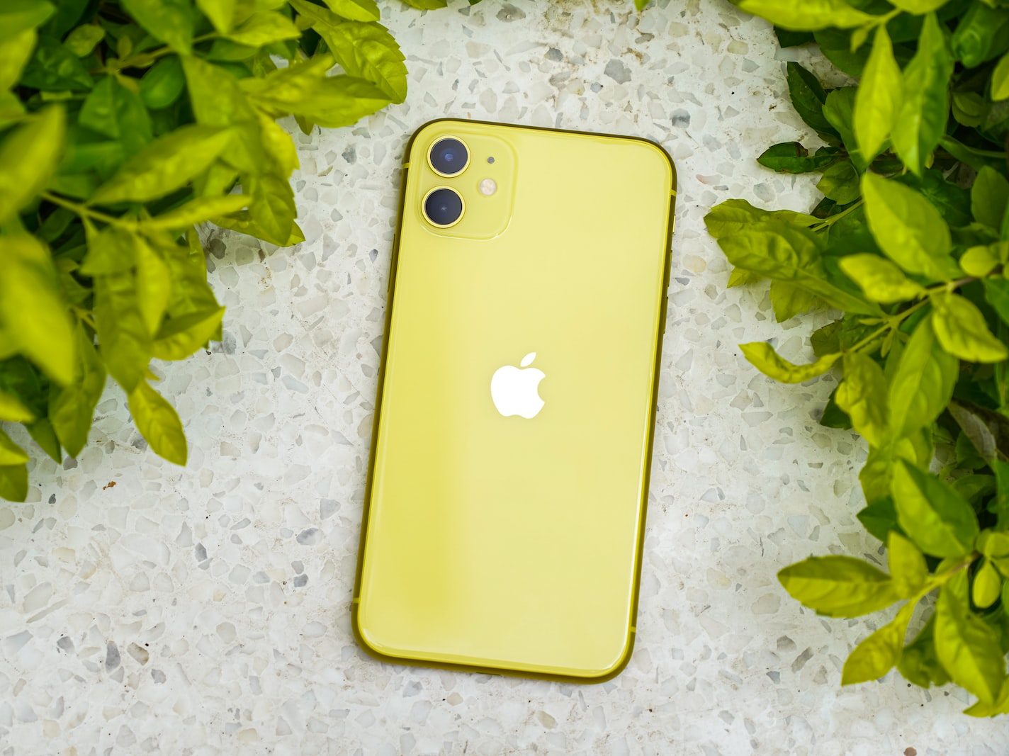 yellow iphone case on white textile