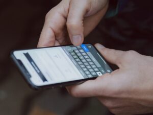 selective focus photography of person using smartphone