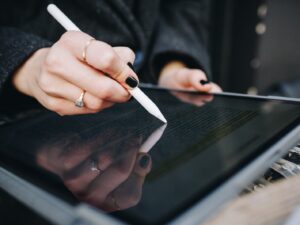 man holding Apple pencil