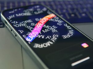 a cell phone sitting on top of a laptop computer