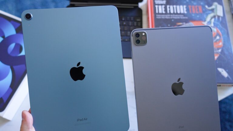 Two ipads side-by-side on a blue surface.