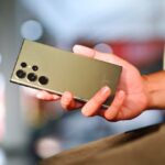 a close up of a person holding a cell phone